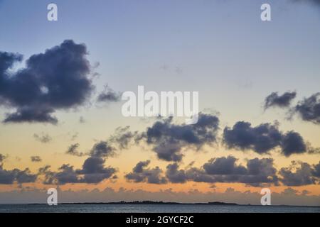Beautiful sunset on the ocean with muted colors Stock Photo