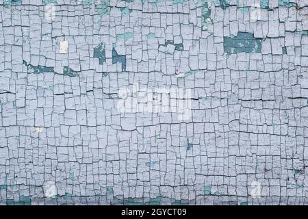 Part of a wooden surface with cracked blue paint Stock Photo