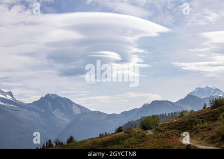 Lenticular cloud formation in a beautiful mountain landcape Stock Photo