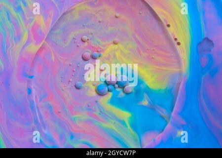 Swirl of light rainbow colors with floating orbs Stock Photo