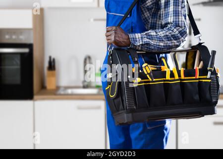 African American Handyman With Repair Box Or Toolbox Stock Photo