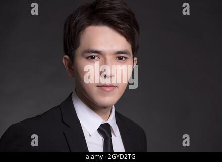 Young handsome man in black suit Stock Photo