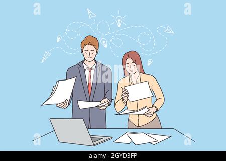 Innovation, Teamwork, new ideas concept. Female and male business partners workers colleagues standing discussing business ideas with documents in off Stock Photo