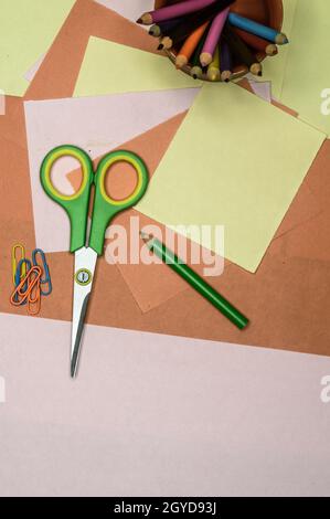 Set of tools for Scrapbook Artist and Paper Crafter. Colour paper, scissors, pencils, paint, and ruler on table. DIY Paper Crafts making creative back Stock Photo
