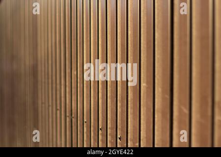 Brown steel fence. Construction fencing in detail. Repeating metal ribs. Stock Photo