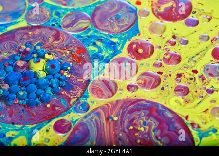 Mesmerizing surface of liquid in rainbow colors with circles and spheres Stock Photo