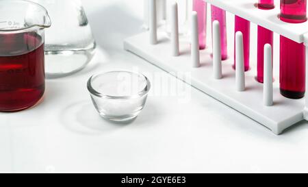 Cosmetic chemicals ingredient on white laboratory table. Potassium Permanganate Liquid,  Alcohol, Microcrystalline wax. Stock Photo