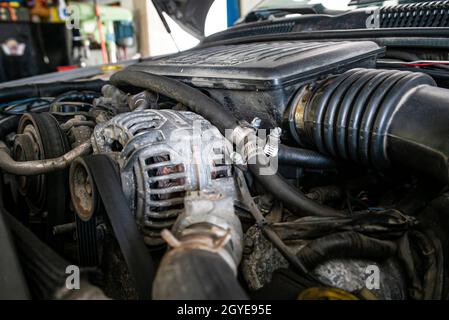 Car engine alternator detail in a mechanical workshop Stock Photo