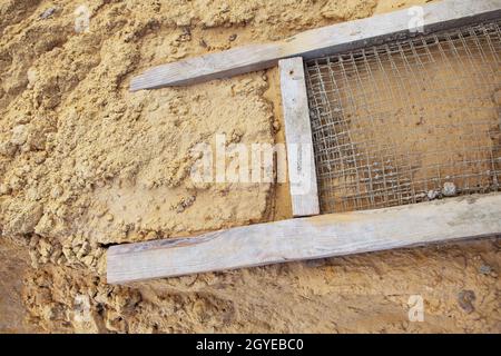 A sieve for sifting sand, all for building a house. View from above Stock Photo