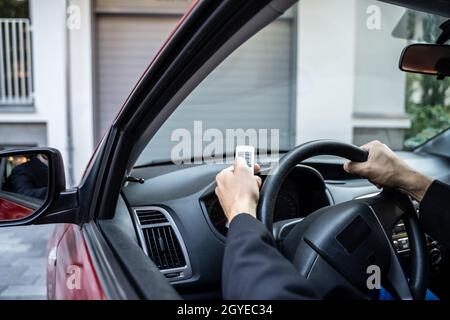 Automatic Wireless Home Garage Door. Hand Using Controller In Car Stock Photo