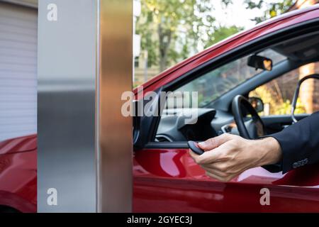 Automatic Wireless Home Garage Door. Hand Using Controller In Car Stock Photo