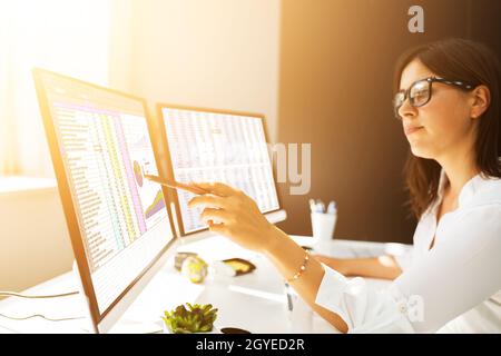Analyst Employee Working With Spreadsheet On Computer Stock Photo