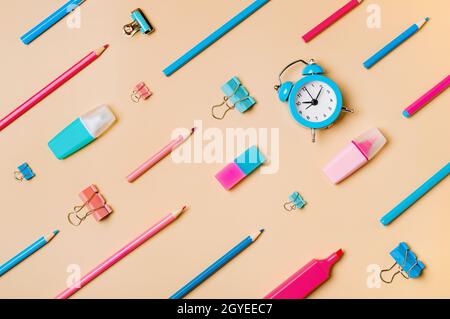 Creative student desk modern school supplies on neutral pastel beige background. Top view flat lay. Back to school concept. Diagonal pattern with penc Stock Photo