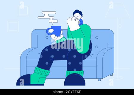 Flu, infection, getting cold concept. Sad ill man cartoon character in warm socks sweater and scarf sitting on sofa with hot drink, sneezing and feeli Stock Photo