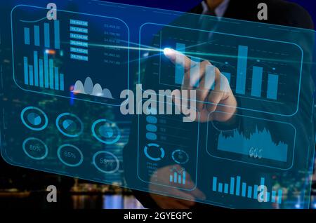 business chart and graph. Businessman touching virtual screen hologram. business technology concept Stock Photo