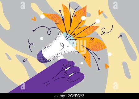 Floral beautiful reminder and announcement concept. Human hand holding bullhorn with blossom blooming flower symbolising positive news and important i Stock Photo