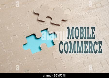 Conceptual caption Mobile Commerce, Concept meaning all online commercial transactions using smartphones Stack of Sample Cube Rectangular Boxes On Sur Stock Photo