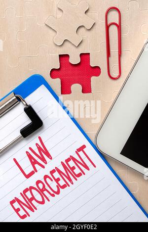Text sign showing Law Enforcement, Internet Concept activity of making certain that the laws of an area are obey Building An Unfinished White Jigsaw P Stock Photo