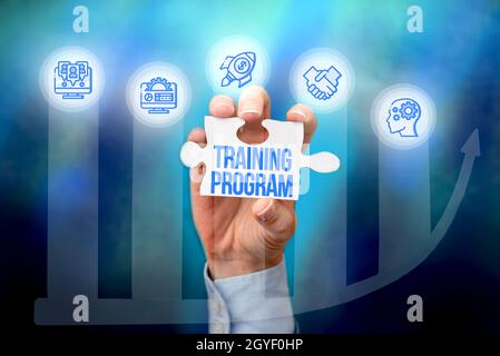 Writing displaying text Training Program, Internet Concept learn specific knowledge or skills to improve performance Hand Holding Jigsaw Puzzle Piece Stock Photo