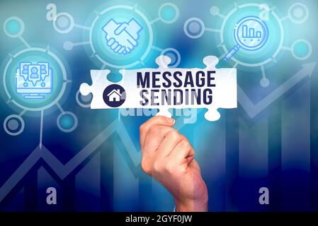 Writing displaying text Message Sending, Business showcase to convey or communicate one s is feelings or desires Hand Holding Jigsaw Puzzle Piece Unlo Stock Photo