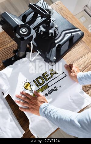 TShirt Print Using Heat Press Machine. Shirt Printing Stock Photo