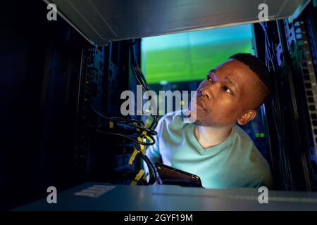 African american male computer technician using tablet and working in server room Stock Photo