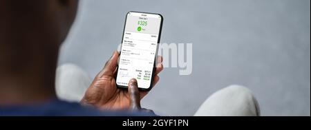African Checking E Invoice Online On Phone Stock Photo