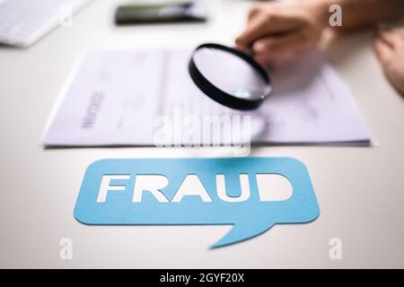 Auditor Doing Tax Fraud Investigation Using Magnifying Glass Stock Photo