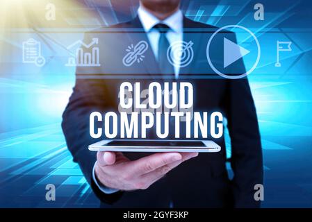 Hand writing sign Cloud Computing, Internet Concept storing and accessing data and programs over the Internet Man In Office Uniform Holding Tablet Dis Stock Photo