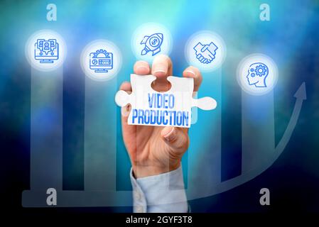 Writing displaying text Video Production, Business overview process of converting an idea into a video Filmaking Hand Holding Jigsaw Puzzle Piece Unlo Stock Photo