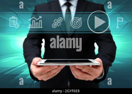 Man In Office Uniform Holding Tablet Displaying New Modern Technology. Stock Photo