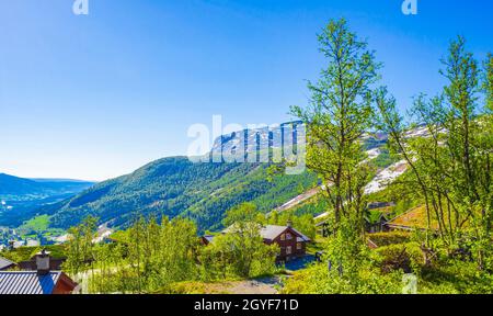 Beautiful landscape panorama of Norway Hemsedal Skicenter with Mountains cabins huts and cloudy sky. Stock Photo