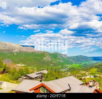 Beautiful landscape panorama of Norway Hemsedal Skicenter with Mountains cabins huts and cloudy sky. Stock Photo