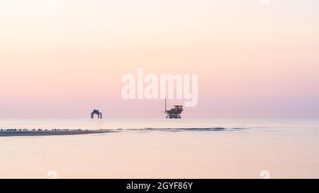Platforms for extraction and transformation of natural gas at sunrise, Adriatic sea, ravenna, italy. Stock Photo