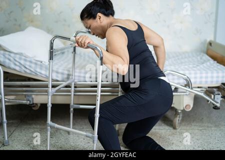 Asian middle-aged lady woman patient falling in living room because slippery surfaces Stock Photo