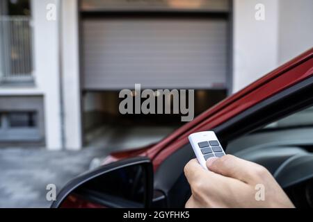 Automatic Wireless Home Garage Door. Hand Using Controller In Car Stock Photo