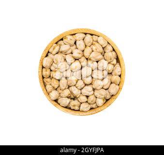 Chickpea seeds or Garganzo beans in brown wooden bowl isolated on white background, top view. Healthy organic super food concept Stock Photo