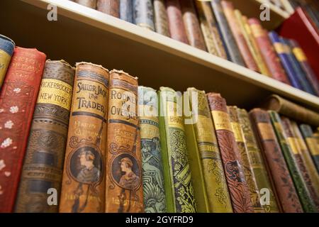 Looking up bookshelf full of old leather books Stock Photo
