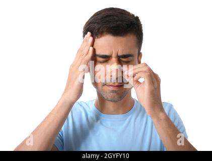 Young man applying plaster onto his nose on white background Stock Photo