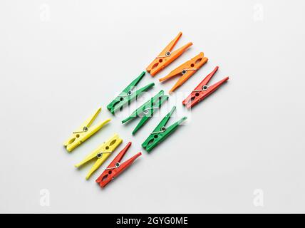 Different plastic clothespins on grey background Stock Photo