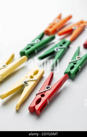 Different plastic clothespins on grey background, closeup Stock Photo