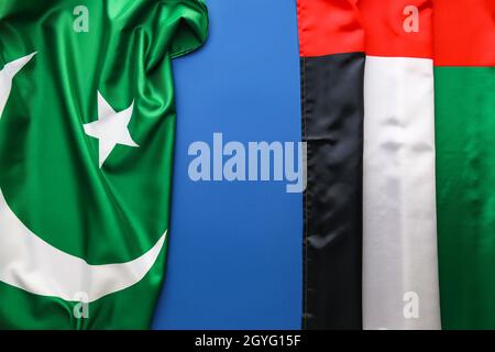 National United Arab Emirates and Pakistan flags on blue background Stock Photo