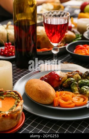 Plate with delicious Thanksgiving dinner and glass of wine on festive served table Stock Photo
