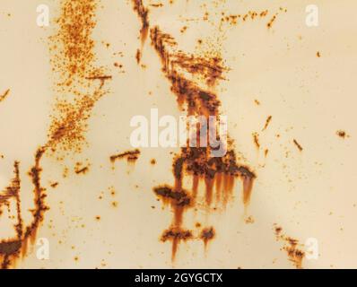 A rusty white metal wall. Metal background with streaks and rust spots. There are rust spots on the metal surface Stock Photo