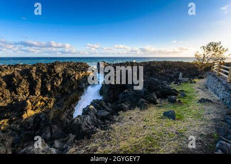 Natural gulf in volcanic rock at Reunion Island close to Etang Sale city Stock Photo