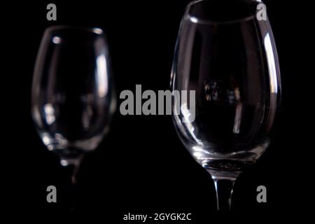 Light reflecting on empty glass goblets with black background Stock Photo