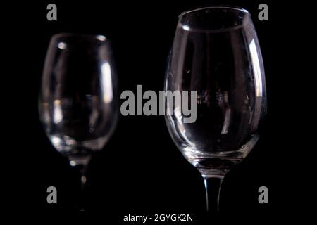 Light reflecting on empty glass goblets with black background Stock Photo