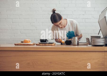 Charming young woman working in coffee shop Stock Photo