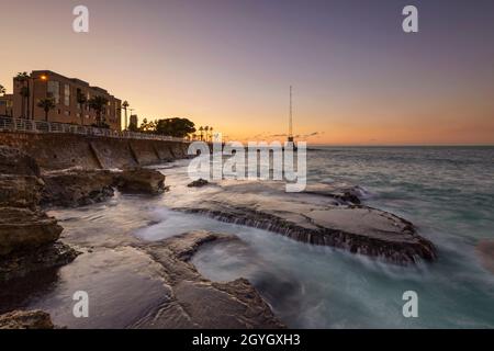 LEBANON, BEIRUT, DAR MREISSE, SEASIDE AT THE FOOT OF THE BEIRUT CORNICHE AT DUSK Stock Photo