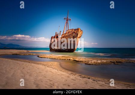 Rusty and abandoned shipwreck of Agios Dimitrios stands on a coastline near Gythio in Lakonia. Peloponnese Greece Stock Photo